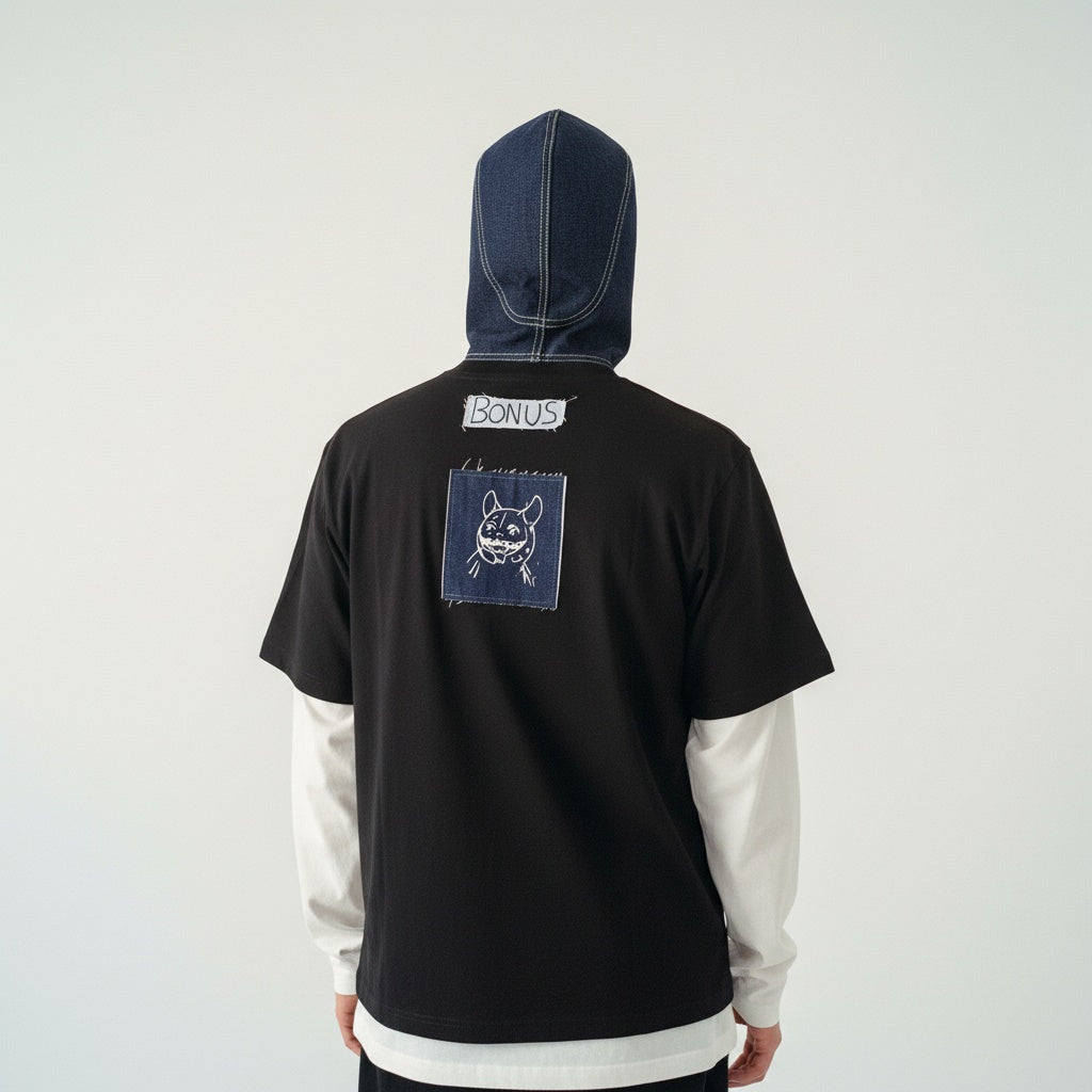Black T-shirt on model — minimalist back view streetwear style — detailed embroidery on denim fabric
